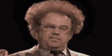 a close up of a man 's face with glasses and a wig