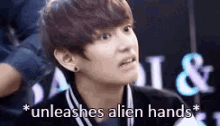 a young man is making a funny face and says `` unleashes alien hands '' .