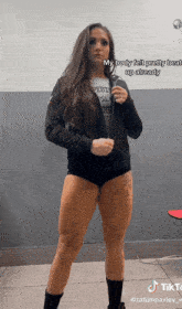 a woman with a tattoo on her leg is wearing shorts and a jacket
