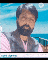 a man with a beard is taking a selfie in front of a blue sky