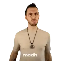 a man in a tan shirt with the word mcdh on the bottom right