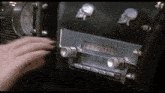 a woman is adjusting a radio in a car with skulls on it .