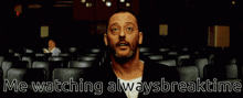 a man sitting in an auditorium with the words me watching alwaysbreaktime