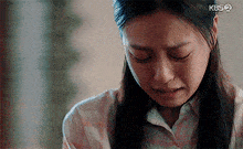 a close up of a woman 's face with tears running down her face .