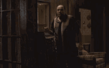 a man standing in a dark room with the words cazzata malinga written on the bottom