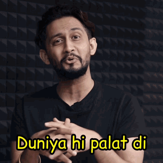 a man wearing a black shirt with the words duniya hi palat di