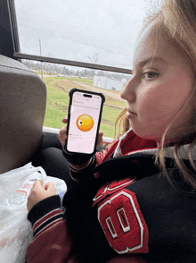 a girl wearing a red jacket with the number 8 on it