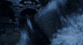a close up of a waterfall with a dark background