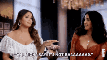 two women sitting at a table with one saying " you might say it 's not baaaaaad "