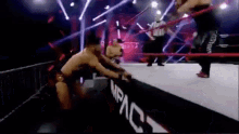 a group of men are wrestling in a ring .