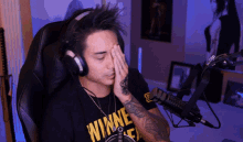 a man wearing headphones and a shirt that says winnie on it