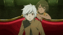 two anime characters sitting on a red couch