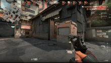 a person holding a gun in front of a building with the number 100 on the bottom right