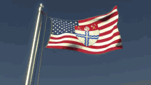 an american flag with a coat of arms on it is flying in the wind