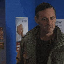 a man in a green jacket with the words what a nice surprise below him