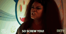 a woman says so screw you in front of a bet + logo