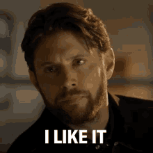 a man with a beard is looking at the camera and saying `` i like it '' .
