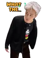 a man in a black jacket and a mickey mouse shirt is asking what the