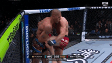 a fighter in a cage with a bud light banner
