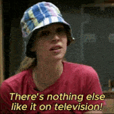a woman is wearing a hat and a red shirt and says there 's nothing else like it on television