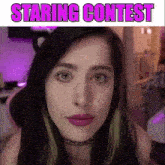 a close up of a woman 's face with the words staring contest written on the bottom .