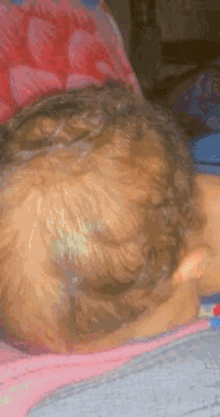 a close up of a child 's head with braids