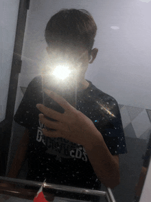 a person taking a picture of themselves in a mirror with a shirt that says brooklyn dodgers