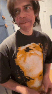 a man wearing a black t-shirt with a picture of a face on it