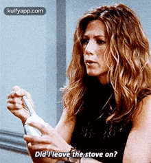 a woman is holding a bottle and asking did i leave the stove on .