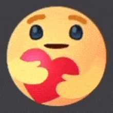 a yellow smiley face with blue eyes is holding a red heart in its mouth .