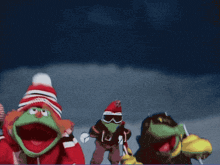 three stuffed animals are skiing down a snowy hill