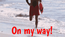 a man carrying a surfboard on the beach with the words on my way written in red