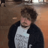 a man with a beard wearing a corporate magazine still suck shirt