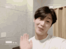 a young man is taking a selfie with a camera that says 30 fps on it