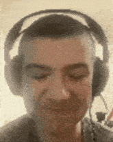 a close up of a man wearing headphones and a microphone