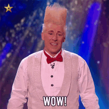 a man wearing a tuxedo and bow tie is saying wow