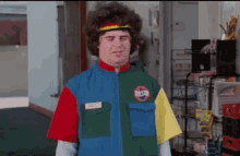 a man wearing a colorful jacket with a sticker on it that says ' subway '