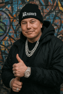 a man wearing a black beanie with blazord on it