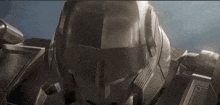 a close up of a robot 's helmet with a blue background .