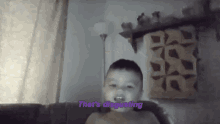 a young boy is sitting on a couch with the words that 's disgusting written above him .