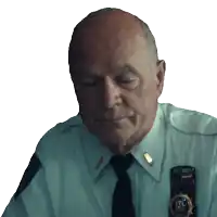 a police officer with his eyes closed has a badge on his shoulder that says ' inspector '