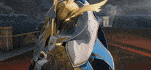 a video game character is wearing a helmet and a blue cape