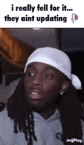 a man with dreadlocks is wearing a white headband and says i really fell for it they ain t updating