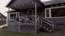 a man sits on a porch of a house