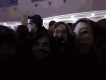 a group of people are posing for a picture together