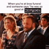 a man in a suit and tie is sitting next to a woman in a crowd of people at a funeral .