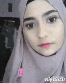 a close up of a woman wearing a hijab