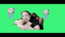 a man wearing a black shirt with the number 0 on it stands in front of a green screen