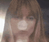 a close up of a woman 's face with a condom on it