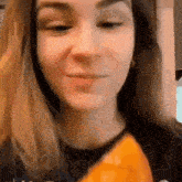 a close up of a woman eating a slice of pizza .